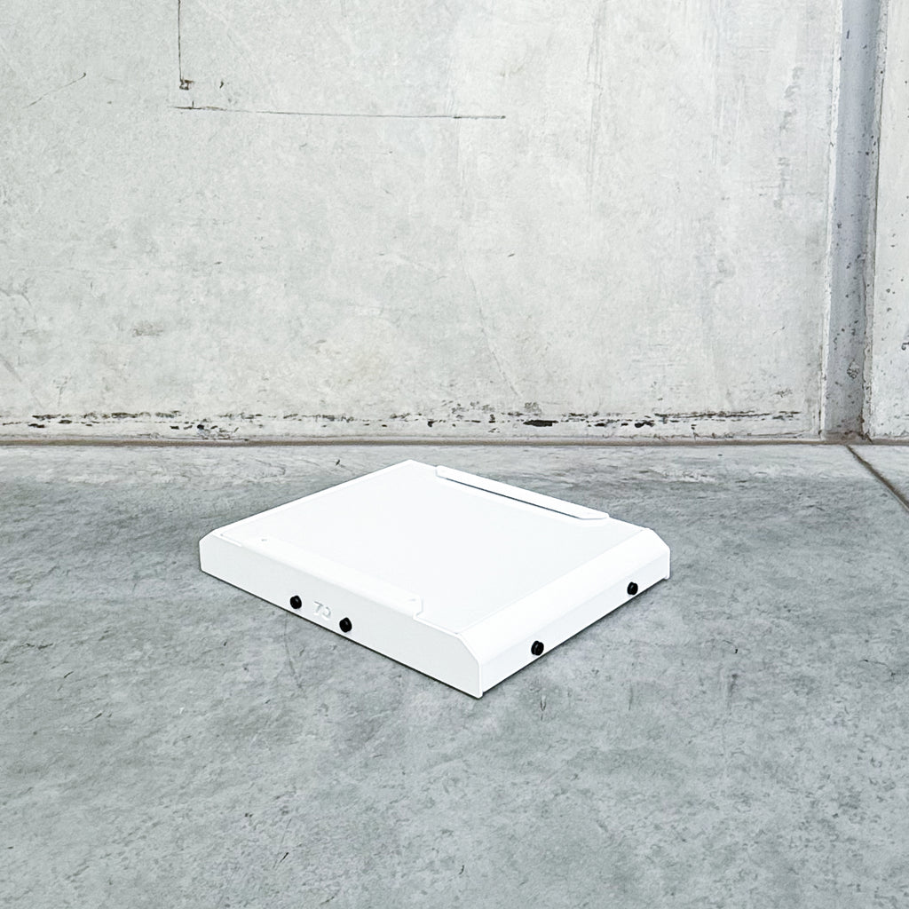 white starlink mount with white cover pictured on concrete background