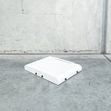 white starlink mount with white cover pictured on concrete background